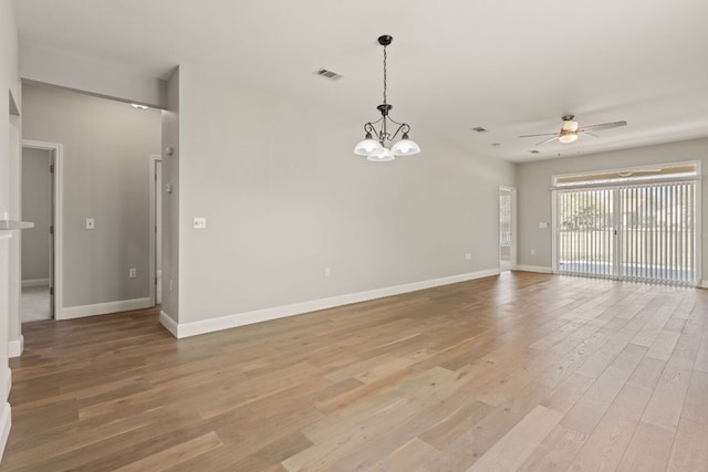 210 Crockett Loop, Georgetown, TX 78633 - unfurnished room with a ceiling fan, light wood-style floors, baseboards, and a chandelier