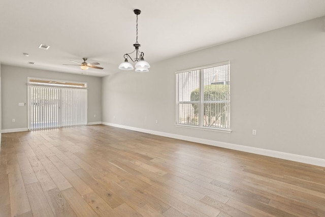 210 Crockett Loop, Georgetown, TX 78633 - empty room with a chandelier, hardwood / wood-style floors, baseboards, and a ceiling fan