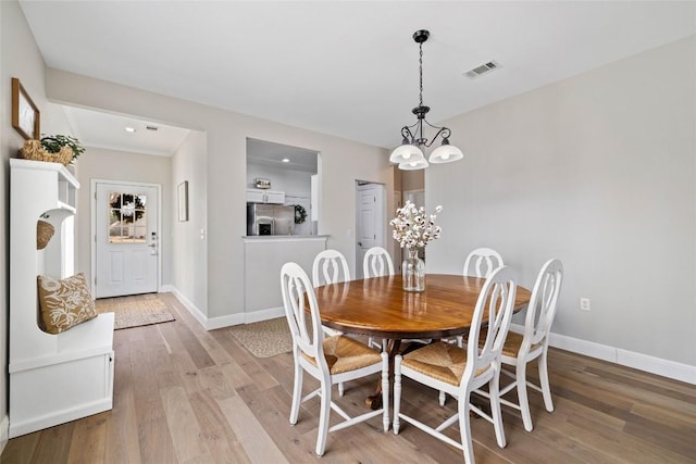 210 Crockett Loop, Georgetown, TX 78633 - dining space featuring a chandelier, light wood finished floors, baseboards, and recessed lighting