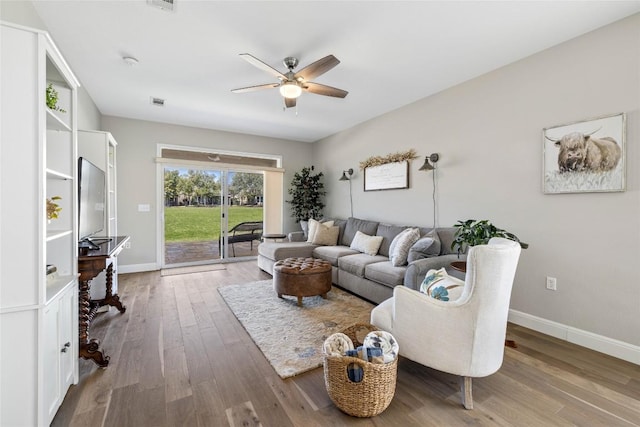 210 Crockett Loop, Georgetown, TX 78633 - living area featuring ceiling fan, wood finished floors, and baseboards