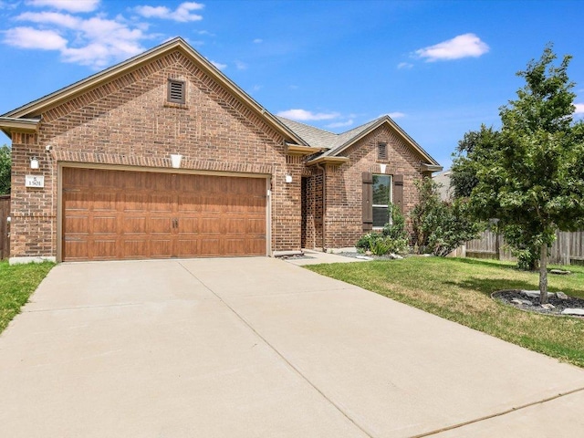 1501 Uhland Dr, Leander, TX 78641 - view of front of house featuring brick siding, a garage, and driveway