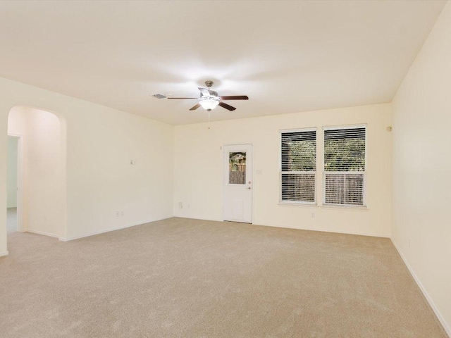1501 Uhland Dr, Leander, TX 78641 - empty room featuring ceiling fan, light carpet, and arched walkways