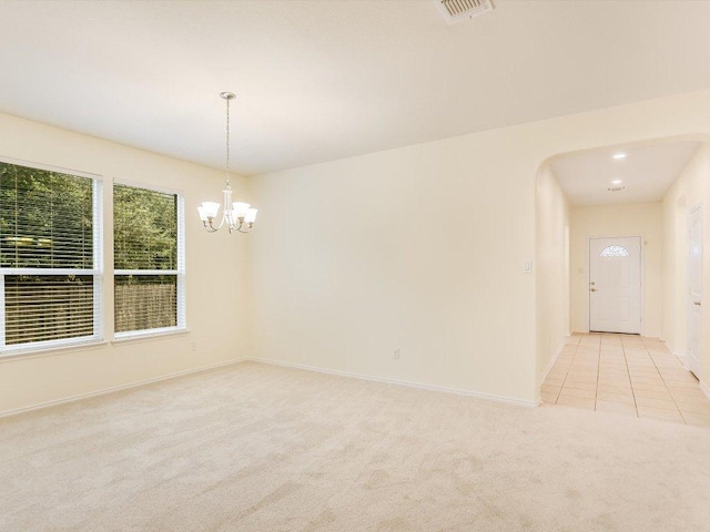 1501 Uhland Dr, Leander, TX 78641 - spare room with light carpet, a chandelier, and arched walkways