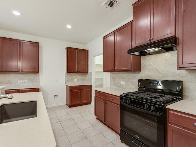 1501 Uhland Dr, Leander, TX 78641 - kitchen featuring gas stove, under cabinet range hood, light countertops, tasteful backsplash, and recessed lighting