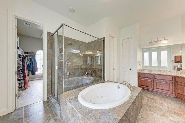 13229 Country Trails Ln, Austin, TX 78732 - bathroom with vanity, a shower stall, a whirlpool tub, and a walk in closet