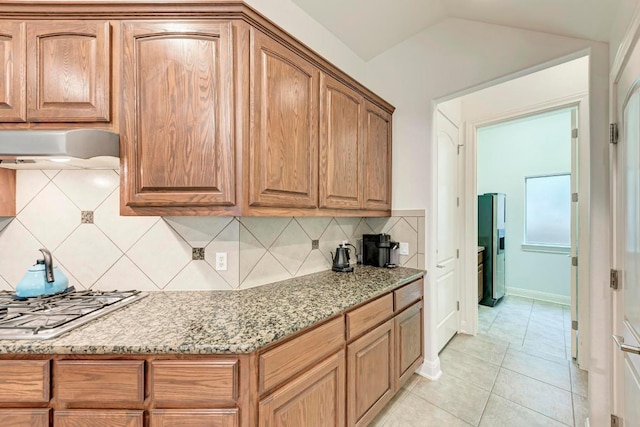 13229 Country Trails Ln, Austin, TX 78732 - kitchen featuring extractor fan, light stone countertops, stainless steel appliances, tasteful backsplash, and light tile patterned flooring