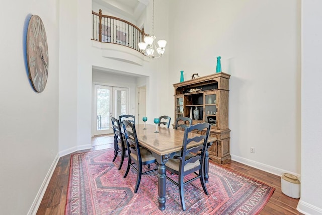 13229 Country Trails Ln, Austin, TX 78732 - dining space with a chandelier, wood finished floors, and a towering ceiling