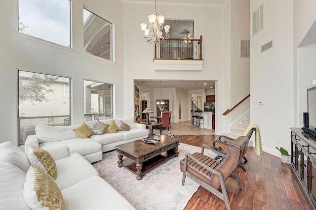 13229 Country Trails Ln, Austin, TX 78732 - living area with a chandelier, stairs, a towering ceiling, and dark wood-type flooring