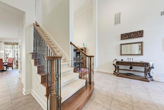 13229 Country Trails Ln, Austin, TX 78732 - staircase featuring tile patterned floors and a high ceiling
