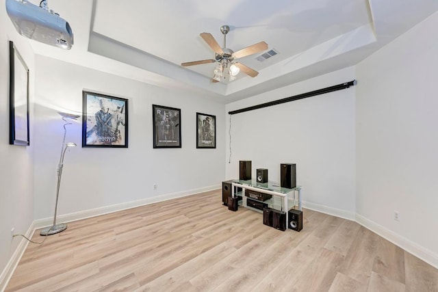 13229 Country Trails Ln, Austin, TX 78732 - cinema with a tray ceiling, a ceiling fan, and wood finished floors