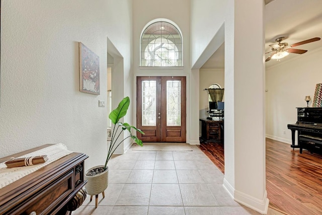 13229 Country Trails Ln, Austin, TX 78732 - entrance foyer with a high ceiling, a ceiling fan, crown molding, light tile patterned floors, and a textured wall