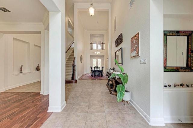 13229 Country Trails Ln, Austin, TX 78732 - entryway with stairway, crown molding, a high ceiling, and a chandelier