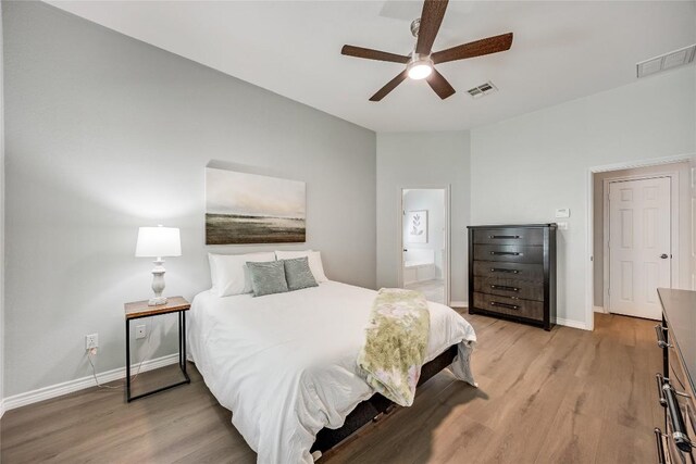 2974 Overland St, Round Rock, TX 78681 - bedroom featuring light wood-style flooring, ensuite bathroom, and a ceiling fan