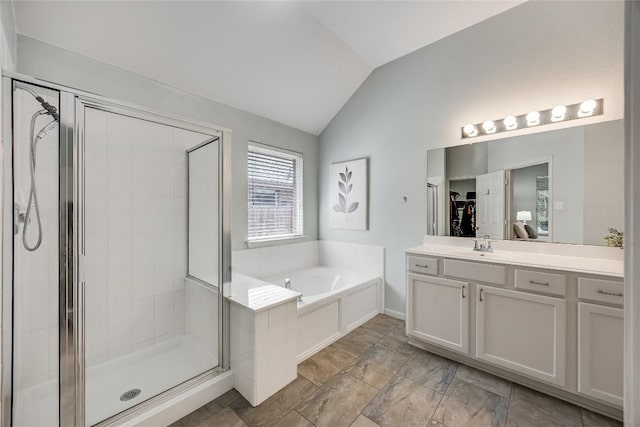 2974 Overland St, Round Rock, TX 78681 - bathroom featuring vaulted ceiling, vanity, a shower stall, a garden tub, and a spacious closet