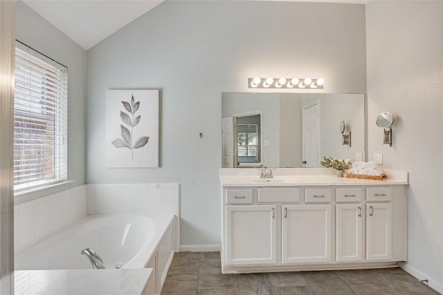 2974 Overland St, Round Rock, TX 78681 - full bathroom with vaulted ceiling, healthy amount of natural light, vanity, and a garden tub