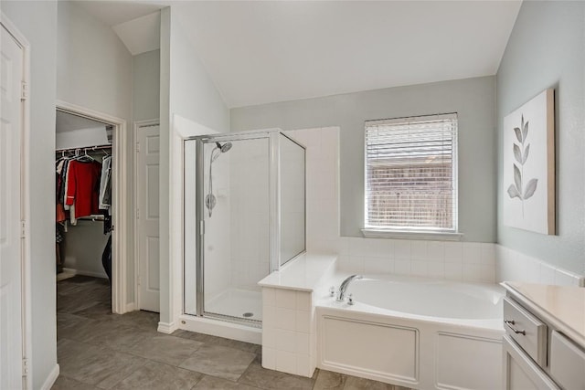 2974 Overland St, Round Rock, TX 78681 - bathroom with a bath, a shower stall, a spacious closet, lofted ceiling, and vanity