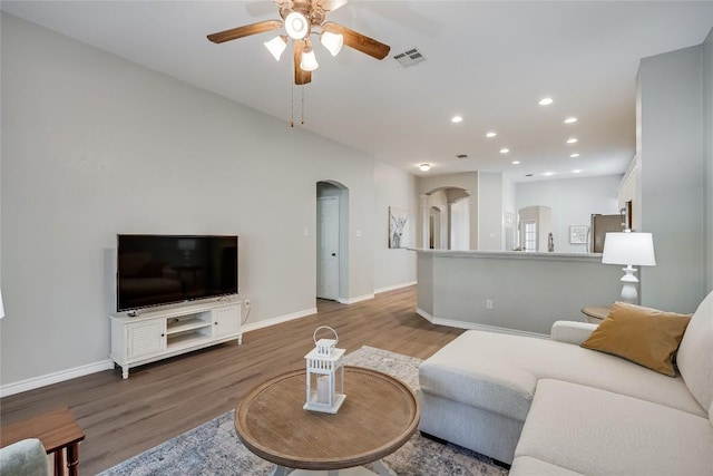2974 Overland St, Round Rock, TX 78681 - living area with arched walkways, ceiling fan, wood finished floors, and recessed lighting