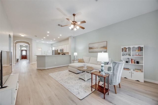 2974 Overland St, Round Rock, TX 78681 - living area featuring arched walkways, ceiling fan, and light wood finished floors