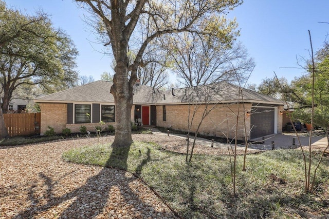 6608 Breezy Pass, Austin, TX 78749 - view of front facade with a garage, brick siding, concrete driveway, and roof with shingles