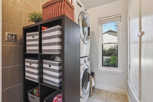 6608 Breezy Pass, Austin, TX 78749 - laundry room featuring estacked washer and dryer, plenty of natural light, and tile patterned floors