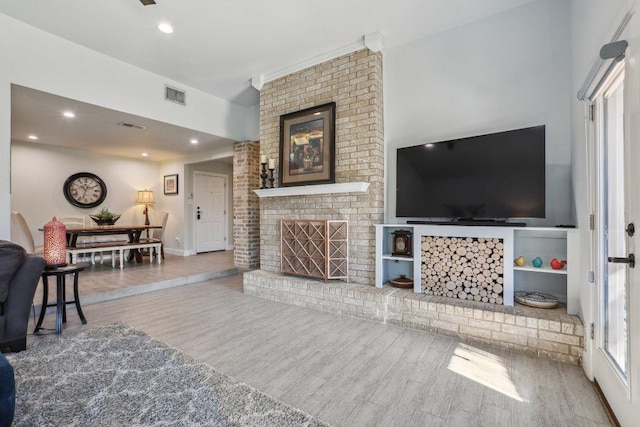 6608 Breezy Pass, Austin, TX 78749 - living area featuring a fireplace, wood finished floors, and recessed lighting