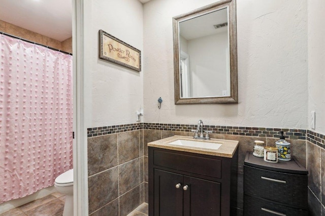 6608 Breezy Pass, Austin, TX 78749 - full bath featuring vanity, tile walls, tile patterned flooring, and a shower with curtain