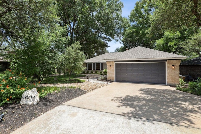 6608 Breezy Pass, Austin, TX 78749 - single story home featuring driveway, brick siding, an attached garage, and roof with shingles