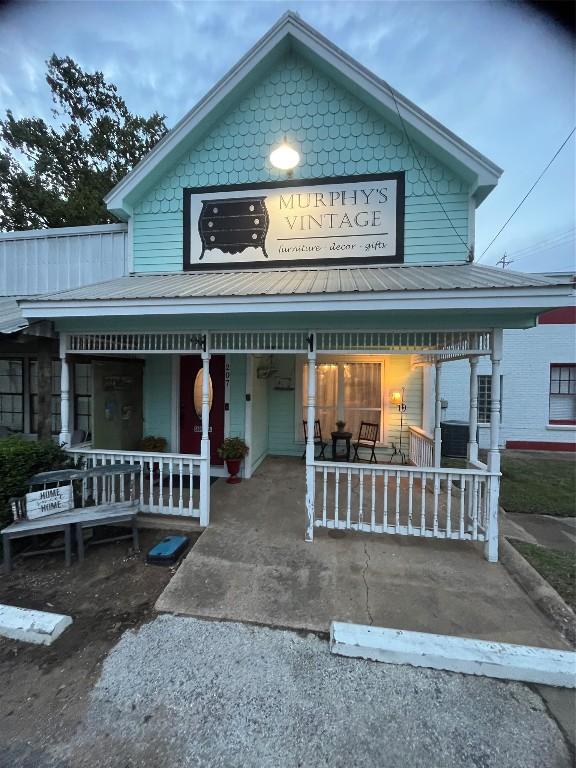 view of front of house with covered porch and metal roof