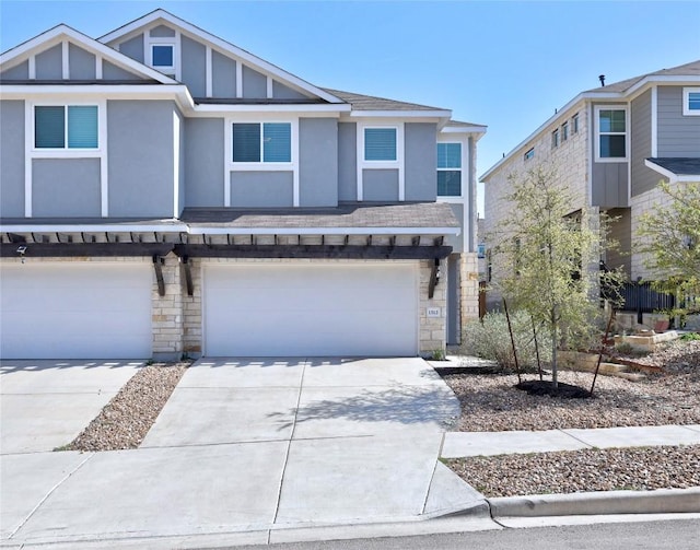 1512 Honaker Way, Leander, TX 78641 - view of property with stone siding, a garage, stucco siding, concrete driveway, and a shingled roof