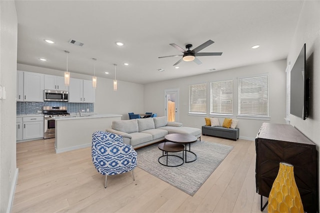 1512 Honaker Way, Leander, TX 78641 - living room featuring light wood-style flooring, a ceiling fan, and recessed lighting
