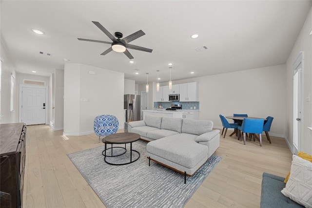 1512 Honaker Way, Leander, TX 78641 - living room featuring ceiling fan, light wood-style floors, baseboards, and recessed lighting