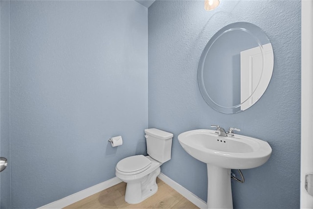 1512 Honaker Way, Leander, TX 78641 - bathroom with wood finished floors, toilet, and baseboards