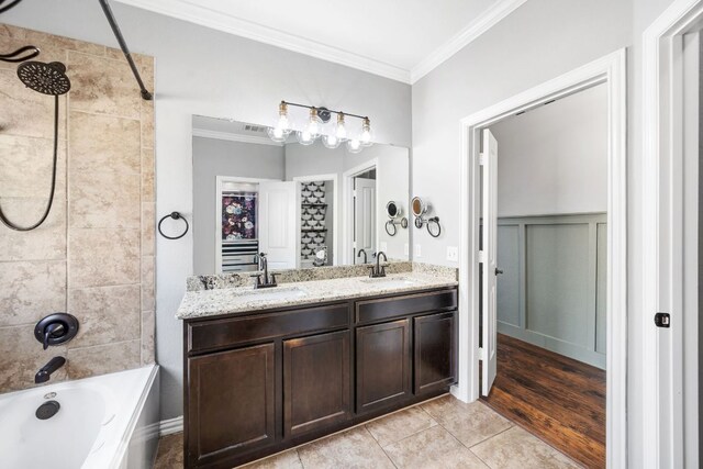 bathroom featuring bathtub / shower combination, ornamental molding, and a sink