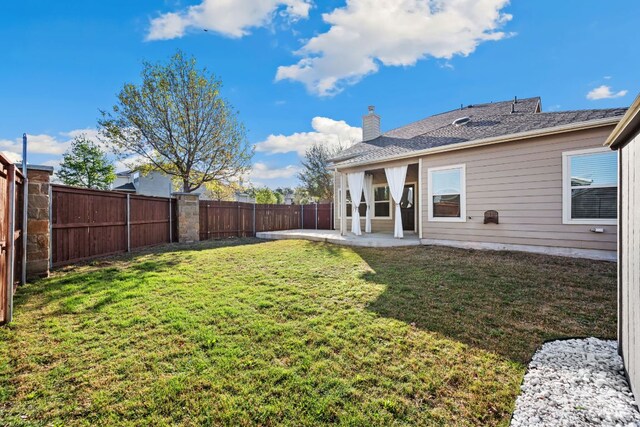 view of yard with a patio and a fenced backyard