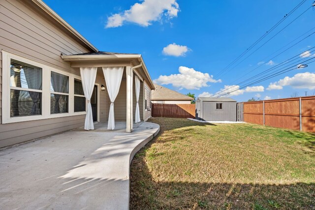 view of yard with a fenced backyard, a patio, an outdoor structure, and a storage shed