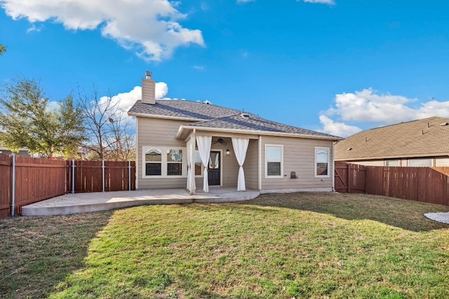 back of property featuring a fenced backyard, a lawn, and a patio area