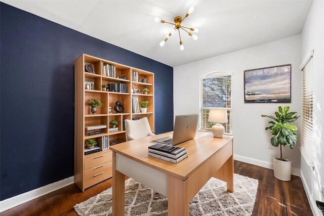 office area with dark wood-style floors, a notable chandelier, and baseboards