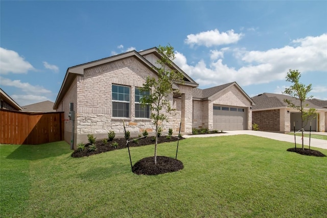 544 Tekoa Dr, Georgetown, TX 78628 - ranch-style home with fence, a front yard, stone siding, concrete driveway, and an attached garage