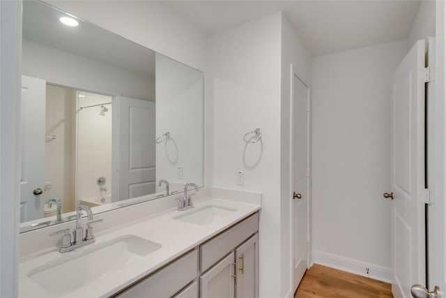 544 Tekoa Dr, Georgetown, TX 78628 - full bathroom featuring double vanity, a sink, baseboards, and wood finished floors