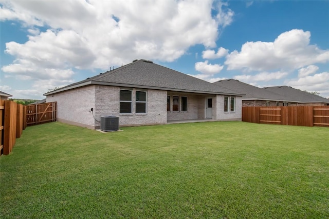 544 Tekoa Dr, Georgetown, TX 78628 - back of house with a shingled roof, brick siding, a fenced backyard, central air condition unit, and a lawn