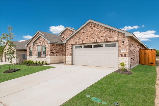 single story home with a garage, driveway, a front lawn, and brick siding