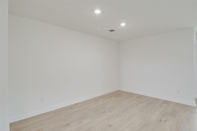 empty room with recessed lighting, baseboards, visible vents, and light wood-style floors