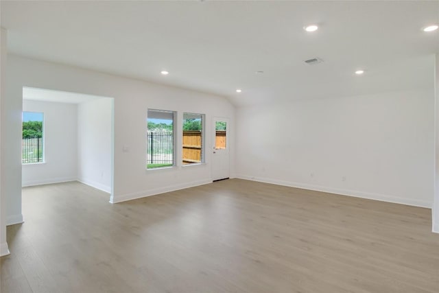 spare room with recessed lighting, baseboards, and wood finished floors