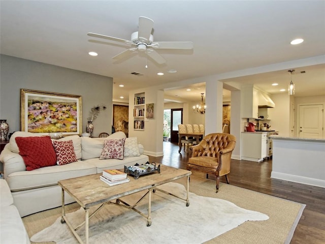 306 Briarwood Trl, Austin, TX 78746 - living room with ceiling fan with notable chandelier, visible vents, baseboards, dark wood-style flooring, and recessed lighting