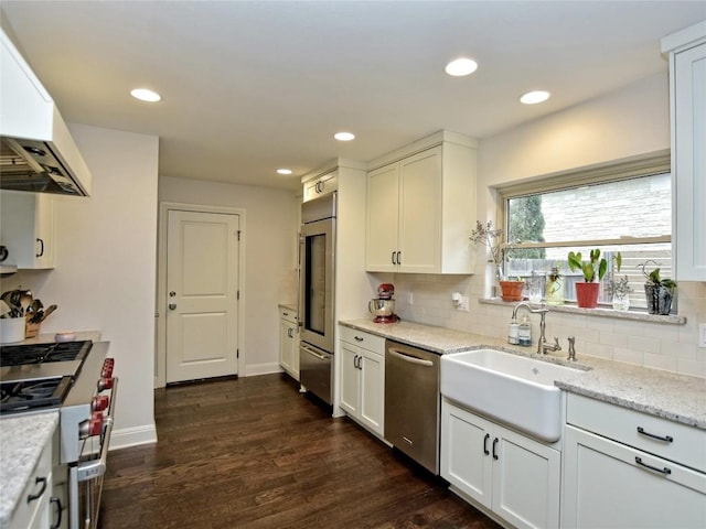306 Briarwood Trl, Austin, TX 78746 - kitchen featuring a sink, white cabinetry, high end appliances, extractor fan, and tasteful backsplash