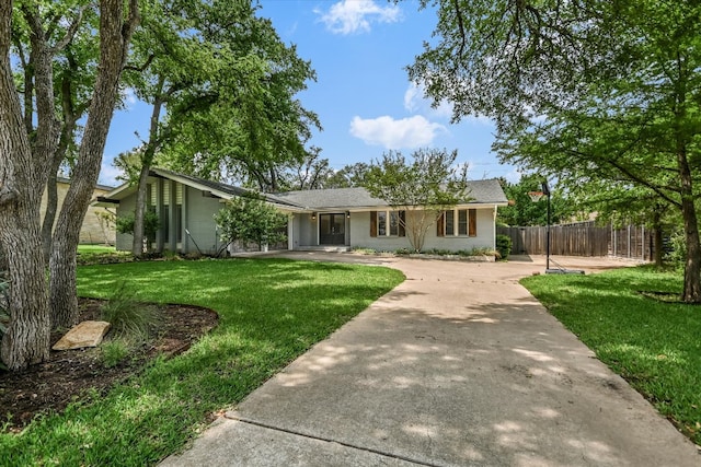 306 Briarwood Trl, Austin, TX 78746 - ranch-style home featuring a front lawn, brick siding, driveway, and fence