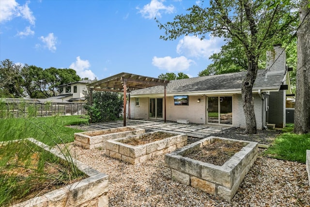 306 Briarwood Trl, Austin, TX 78746 - back of property with a pergola, a shingled roof, a vegetable garden, brick siding, and a patio area