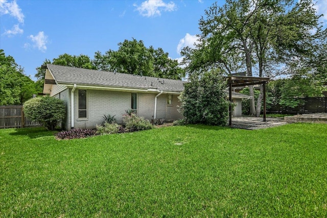 306 Briarwood Trl, Austin, TX 78746 - rear view of house with fence, a patio area, brick siding, a yard, and a shingled roof