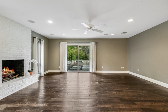 306 Briarwood Trl, Austin, TX 78746 - unfurnished living room with a ceiling fan, baseboards, dark wood finished floors, visible vents, and a fireplace