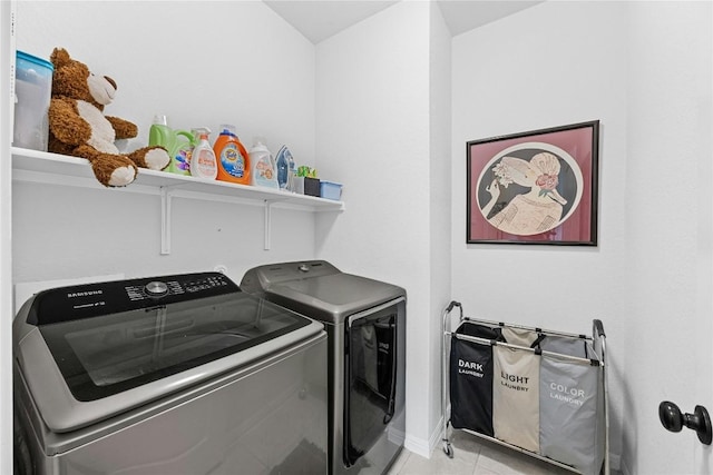 200 Isabella Way, Liberty Hill, TX 78642 - laundry area featuring washing machine and clothes dryer, light tile patterned floors, and baseboards
